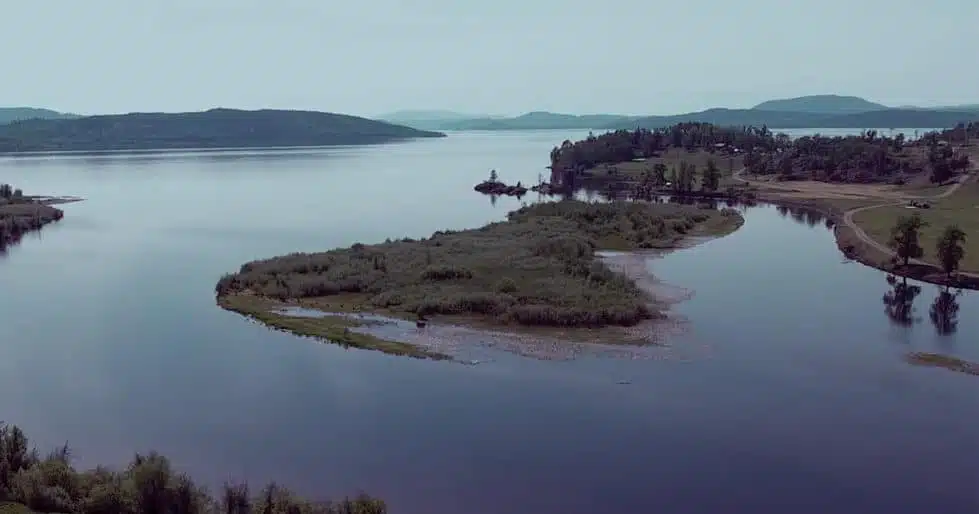 A lake with a green peninsula and an island